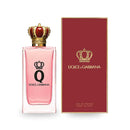 Dolce & Gabbana Q Eau De Parfum bottle with crown design and red box featuring elegant branding.