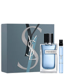 Y Eau De Parfum set with bottle and travel spray, showcasing earthy and woody fragrance notes.