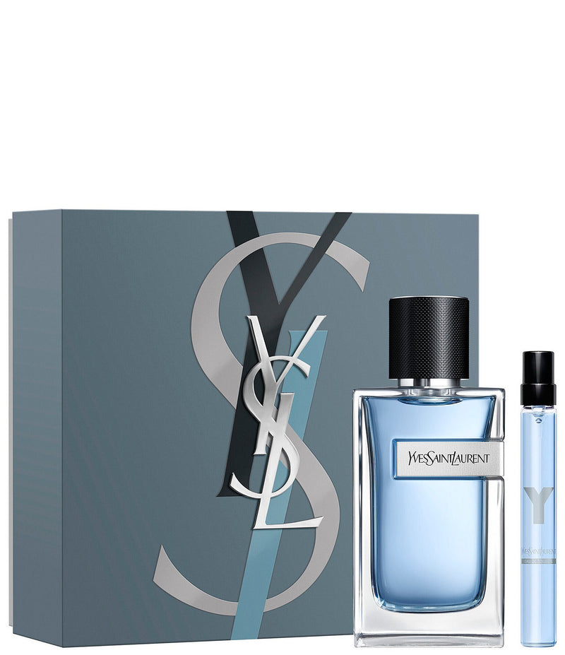 Y Eau De Parfum set with bottle and travel spray, showcasing earthy and woody fragrance notes.